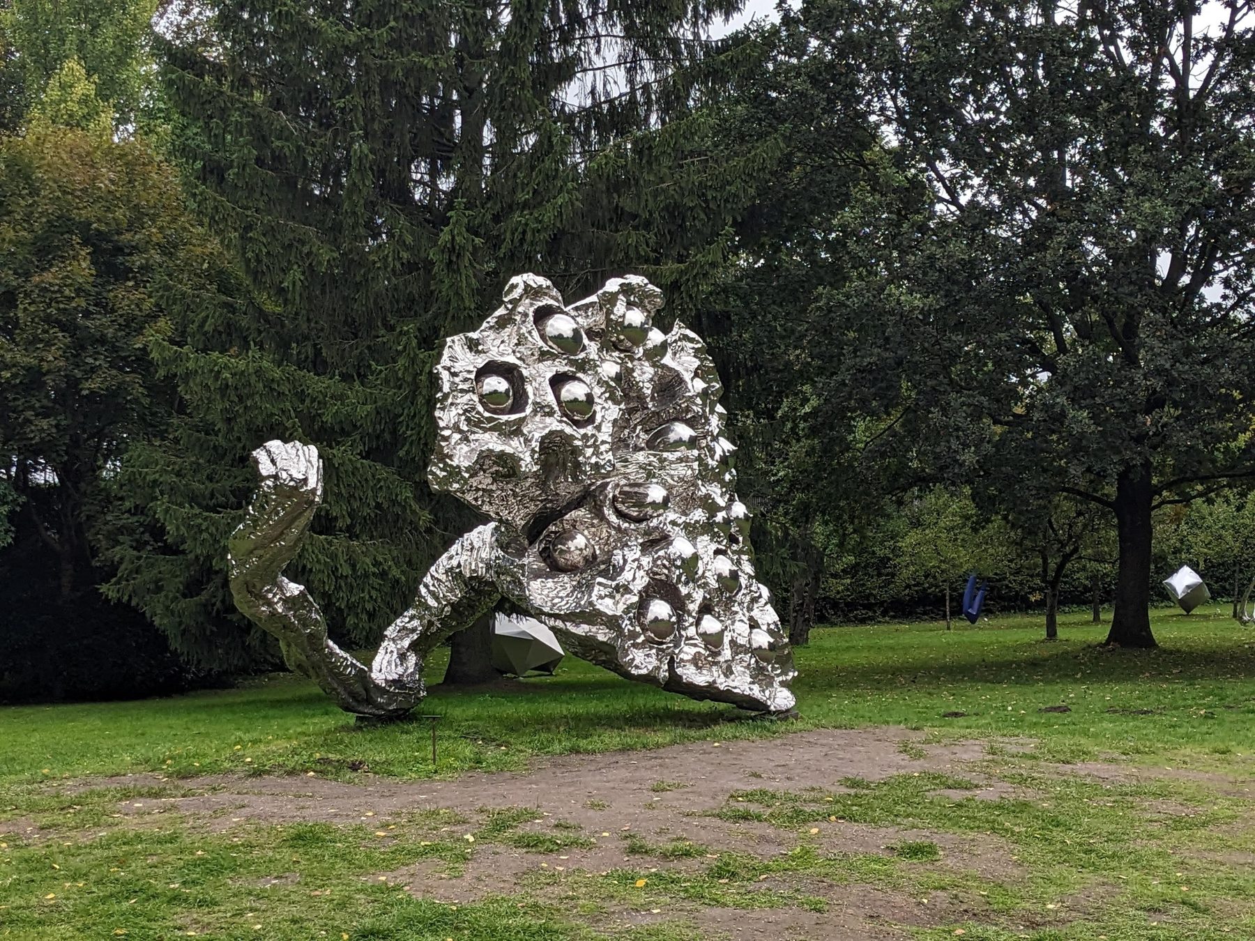Seitliche Ansicht der spiegelnden Edelstahlskulptur Lotus Talks von Zeng Chenggang